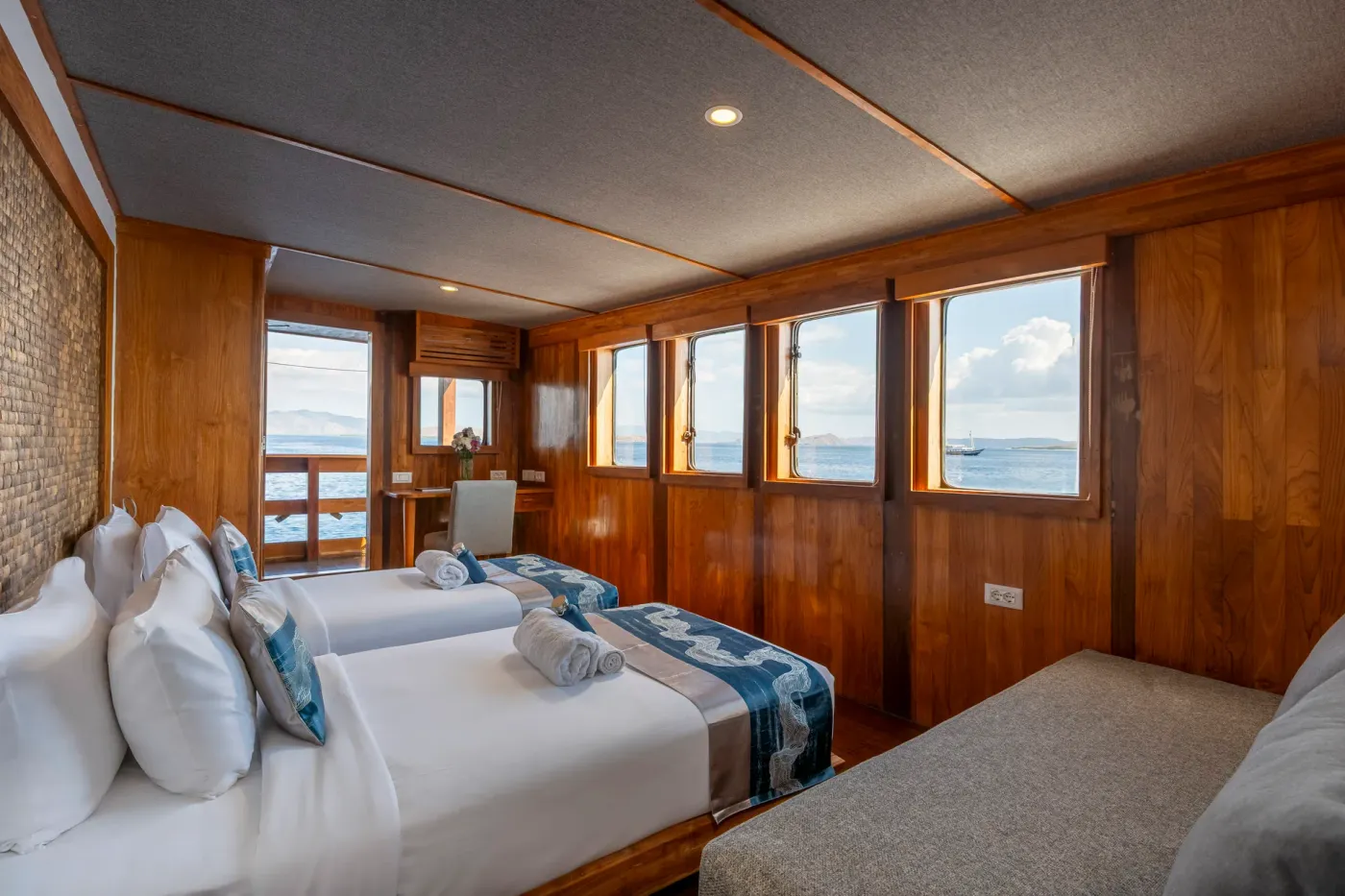 Double cabin with a king bed and private balcony doors on the Komodo Sea Dragon liveaboard