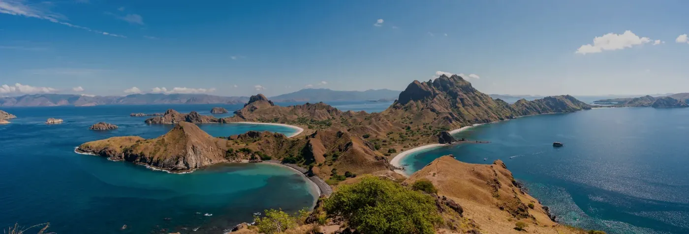 Panoramic view from the Padar Island viewpoint over three curved bays in Komodo National Park