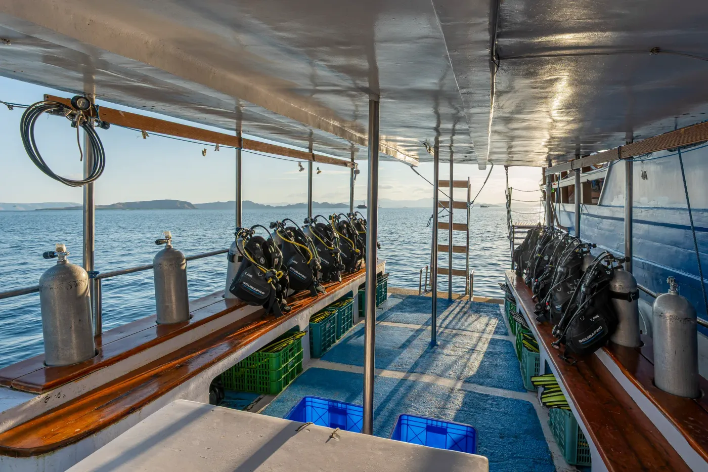 Dive deck with tanks and kit stations on the Komodo Sea Dragon liveaboard in Komodo National Park