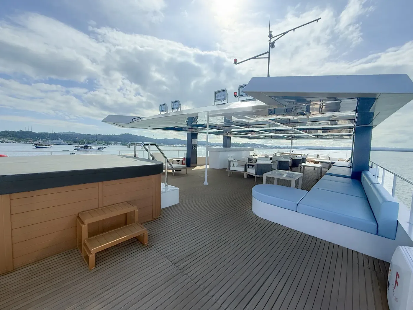 Shaded upper deck lounge on an Indonesian liveaboard, where surface intervals and skipped dives are spent