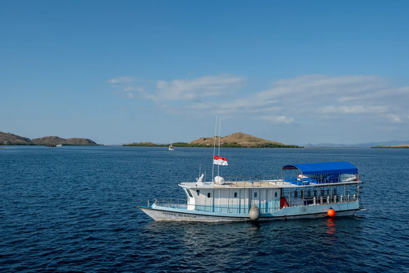 Detached dive boat of the Komodo Sea Dragon liveaboard at anchor in Komodo National Park